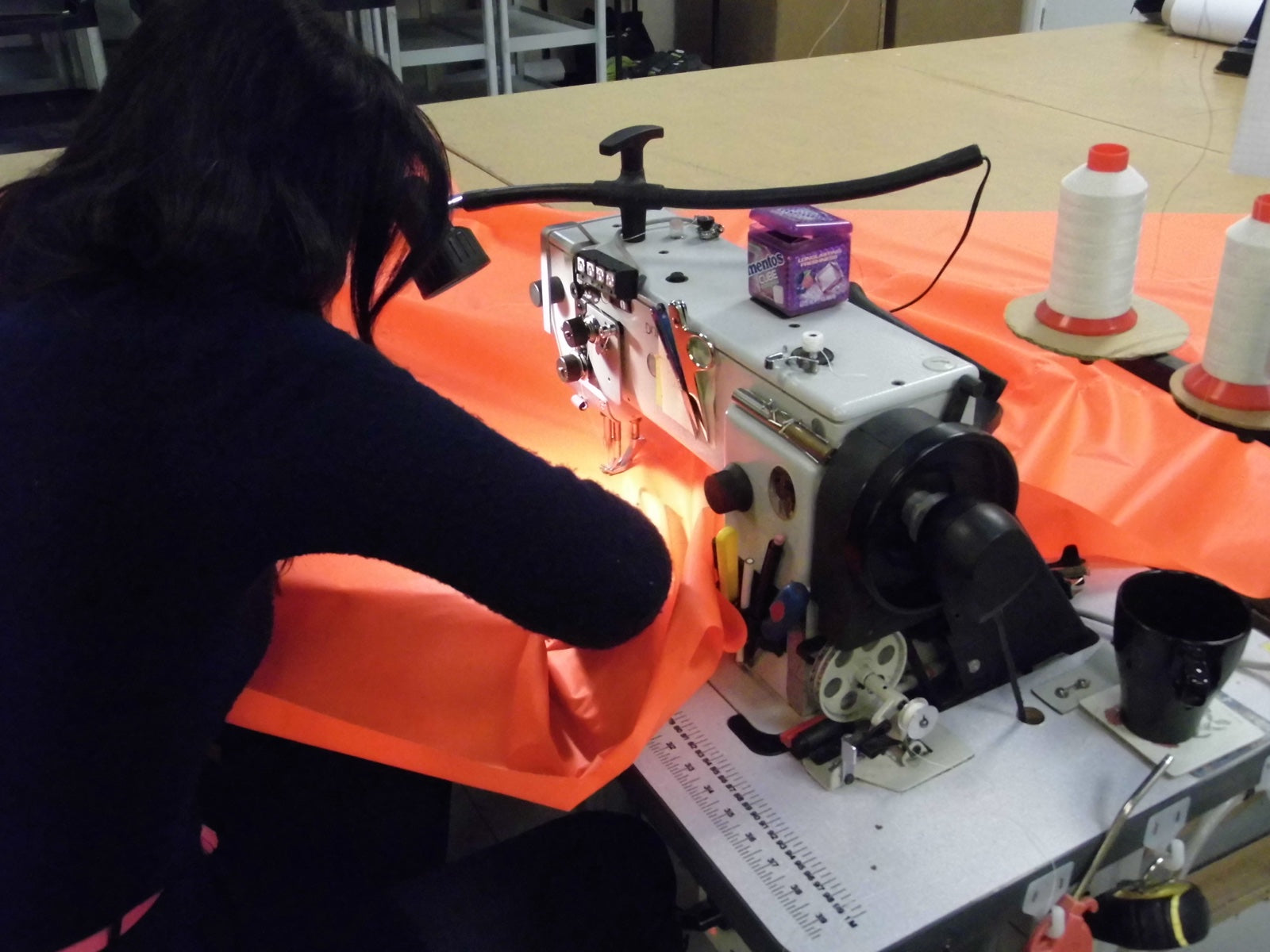 Close-up of industrial sewing machine finishing the windsock hem